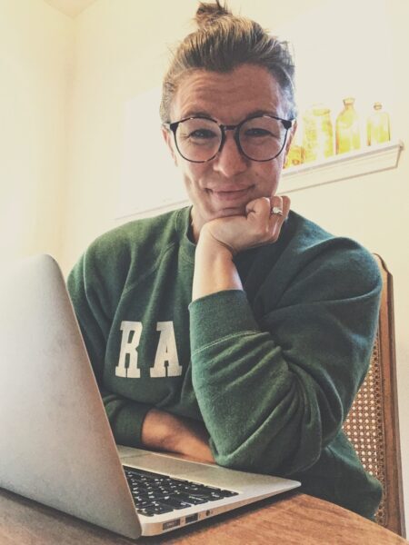 Amanda Davis, pelvic floor physical therapist, sitting in front of computer with headphones in