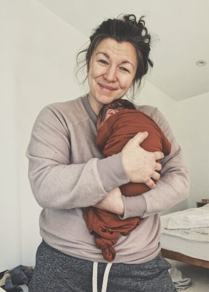Amanda Davis, pelvic floor physical therapist, holding baby