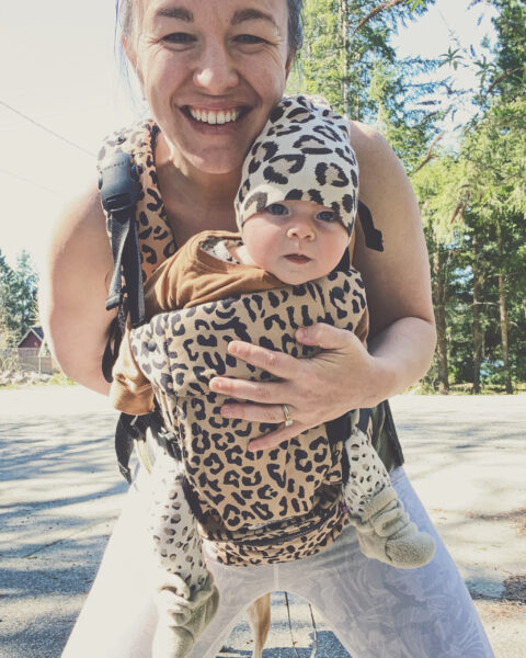 Amanda Davis, DPT, carrying baby in a leopard carrier