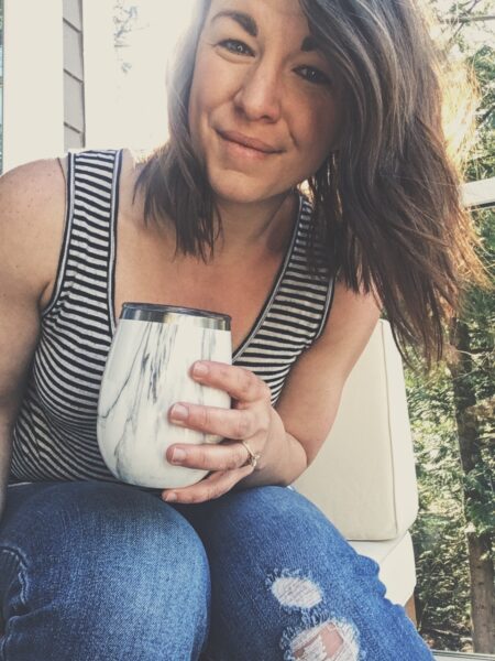 Amanda Davis, DPT, PRPC holding coffee cup on porch