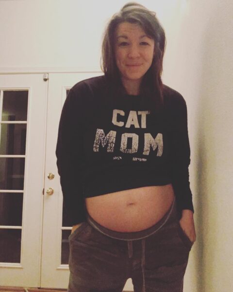 Dr. Amanda Davis, pelvic floor physical therapist, pregnant in black sweatshirt