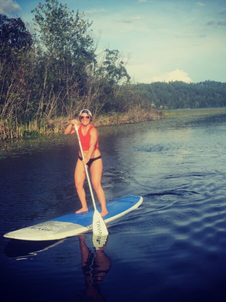 Woman standing on paddle board in the middle of the lake