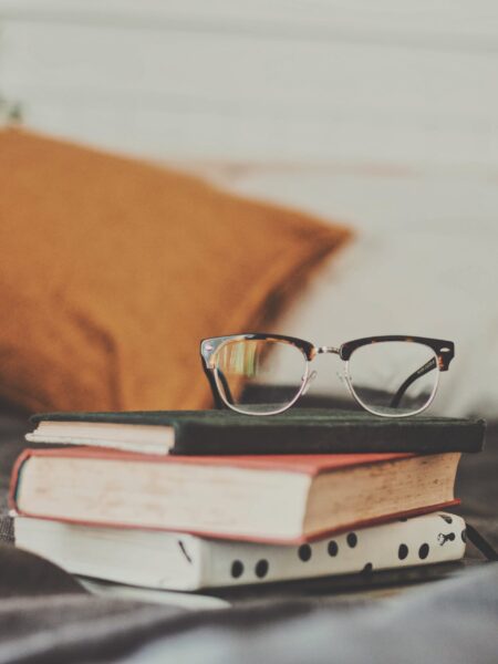 Stack of books with glasses on top