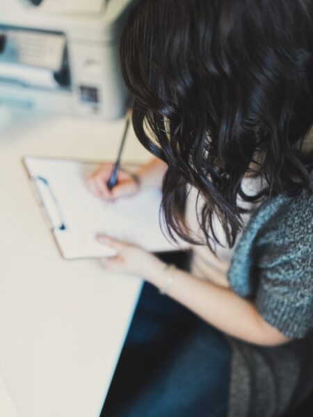 Dr. Amanda Davis, pelvic rehab therapist, writing a letter