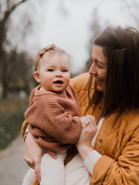 Dr. Amanda Davis, pelvic rehab therapist, hold and smiling at daughter