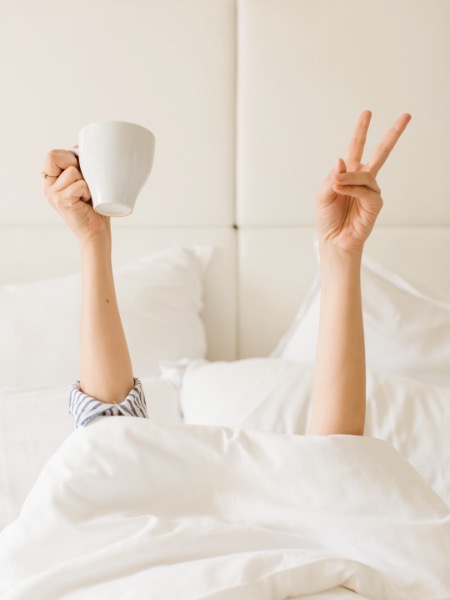person in bed starting morning routine